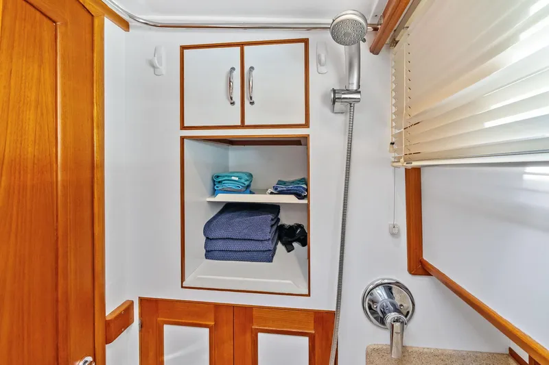 Slide: The Image of Bathroom interior of 2006 Grand Banks Europa 47 yacht with wooden cabinetry and shower. - 48