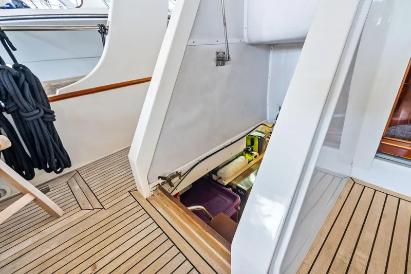 Slide: The Image of 2006 Grand Banks Europa 47 yacht with open storage compartment on teak deck. - 50