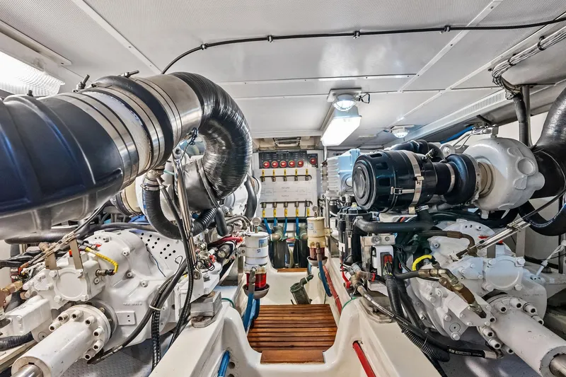 Slide: The Image of Engine room of 2006 Grand Banks Europa 47 yacht, showcasing mechanical components and systems. - 53