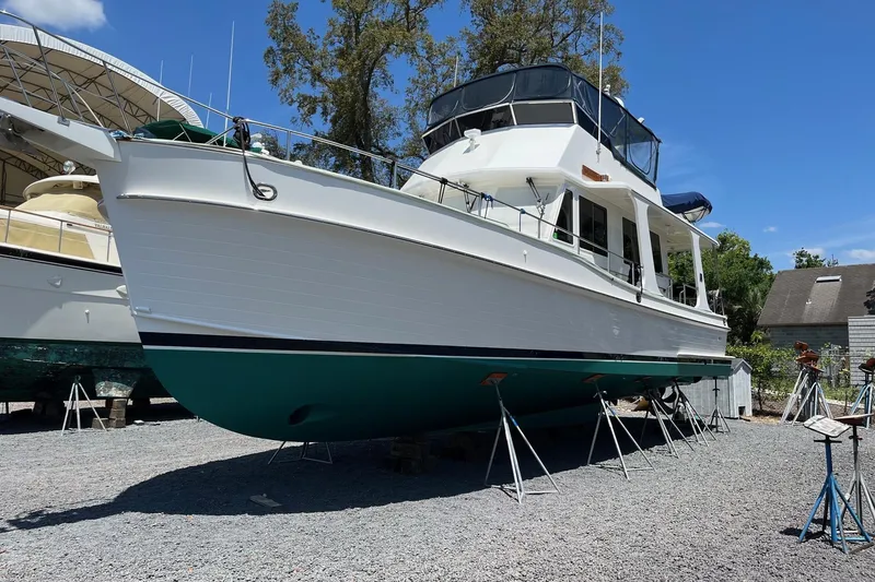Slide: The Image of 2006 Grand Banks 47 Heritage EU yacht on stands, displayed outdoors under clear blue sky. - 60