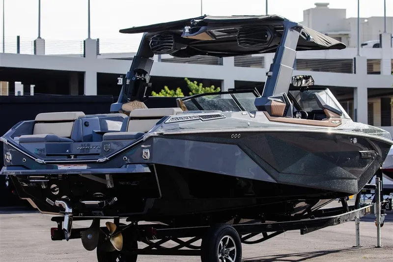 Slide: The Image of 2023 Nautique Super Air Nautique G23 Paragon boat on trailer, sleek design, luxury features. - 1