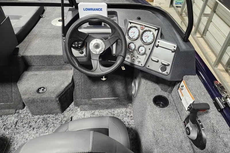 Slide: The Image of 2026 Tracker Pro Guide V-175 Combo boat cockpit with steering wheel and instrument panel. - 4