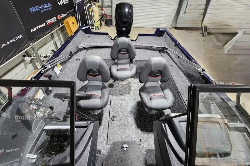 Slide: The Image of 2026 Tracker Pro Guide V-175 Combo boat interior with four gray seats and control panel. - 6