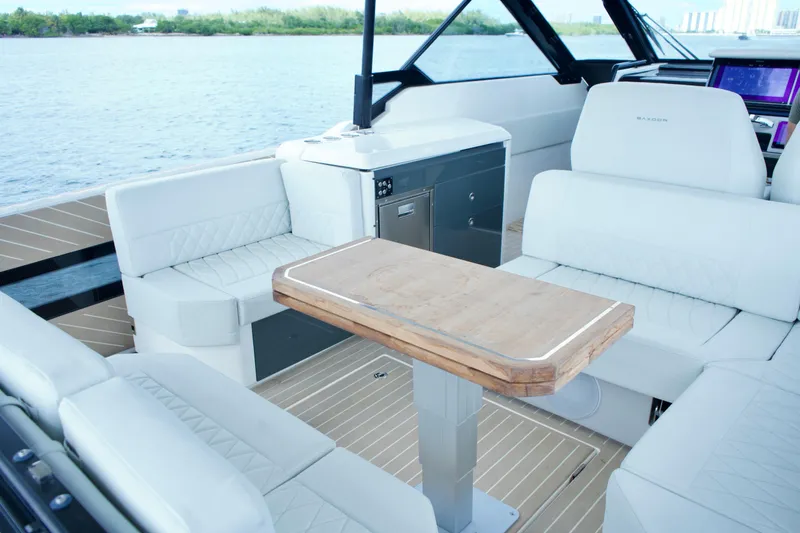 Slide: The Image of 2025 Saxdor 400 GTO luxury boat interior with white seating and wooden table. - 17
