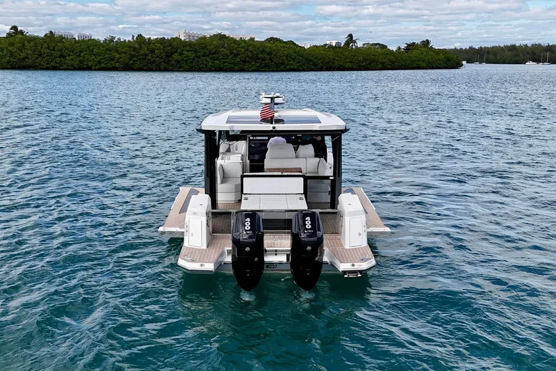 Slide: The Image of 2025 Saxdor 400 GTO luxury boat on serene water with dual engines. - 5