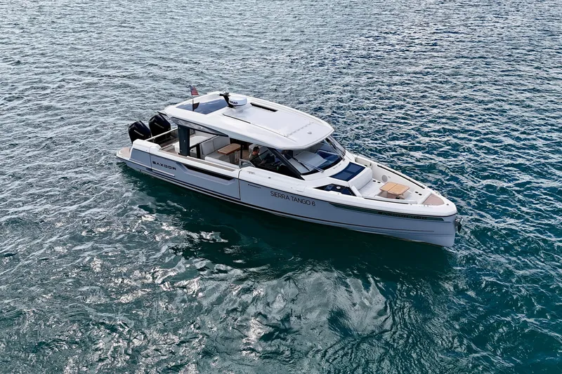 Slide: The Image of 2025 Saxdor 400 GTO luxury boat cruising on open water. - 8