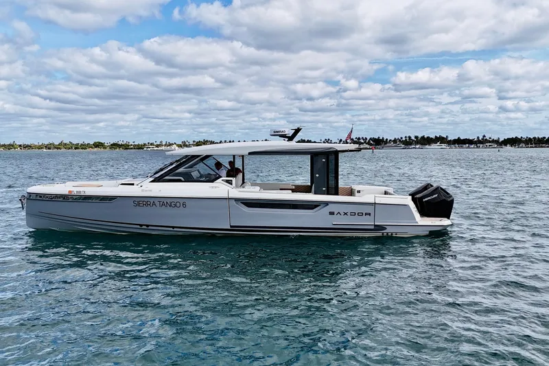 Slide: The Image of 2025 Saxdor 400 GTO luxury boat cruising on a calm sea under a cloudy sky. - 9