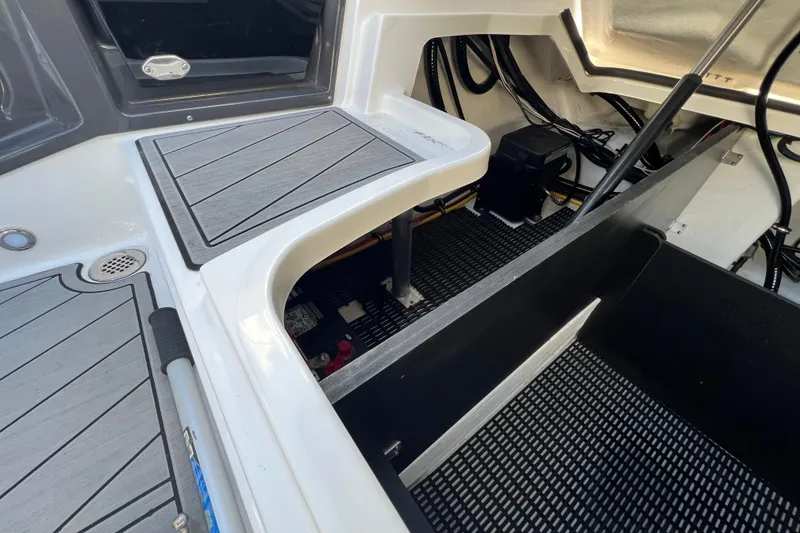 Slide: The Image of 2023 Monterey 275SS Super Sport boat interior with storage compartments and sleek design. - 19