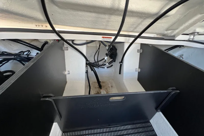 Slide: The Image of 2023 Monterey 275SS Super Sport engine compartment with wiring and storage space. - 21