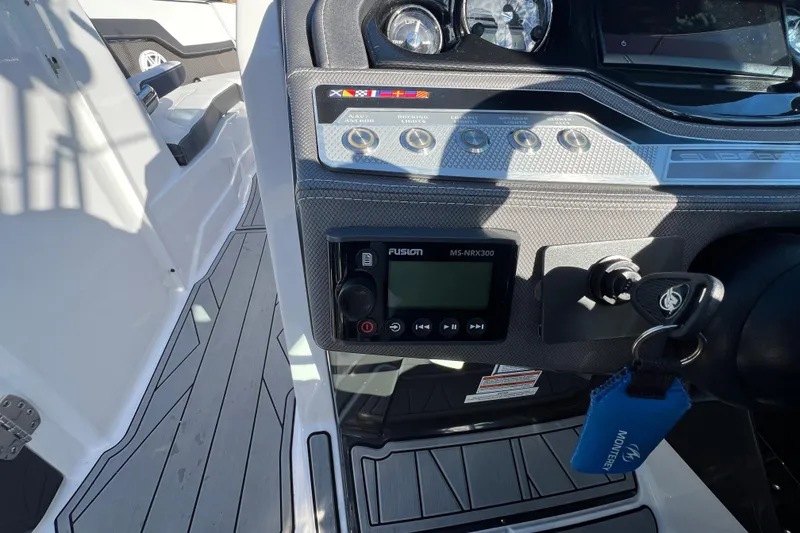 Slide: The Image of Dashboard of 2023 Monterey 275SS Super Sport boat with control panel and key. - 22