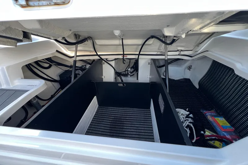 Slide: The Image of 2023 Monterey 275SS Super Sport boat storage compartment with organized cables and accessories. - 24