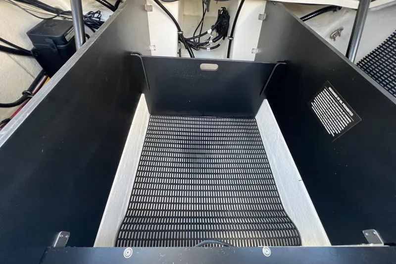 Slide: The Image of Storage compartment of 2023 Monterey 275SS Super Sport boat, featuring black and white interior. - 25