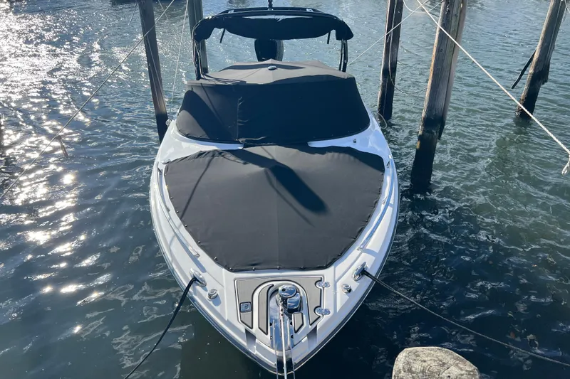 Slide: The Image of 2023 Monterey 275SS Super Sport boat docked with black cover. - 27