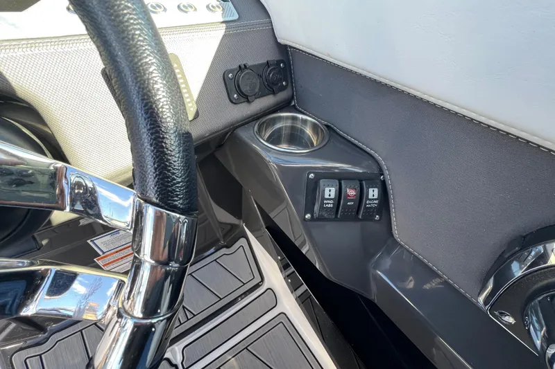 Slide: The Image of 2023 Monterey 275SS Super Sport dashboard with steering wheel, cup holder, and control switches. - 29