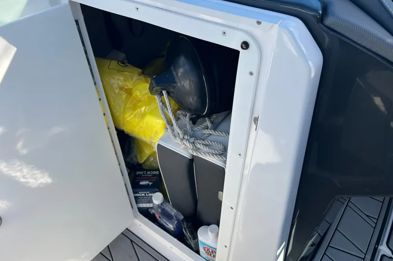 Slide: The Image of Storage compartment on 2023 Monterey 275SS Super Sport boat with ropes and supplies. - 33