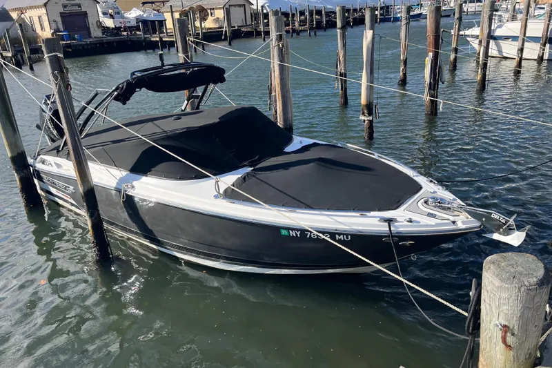 Slide: The Image of 2023 Monterey 275SS Super Sport boat docked in a marina. - 34