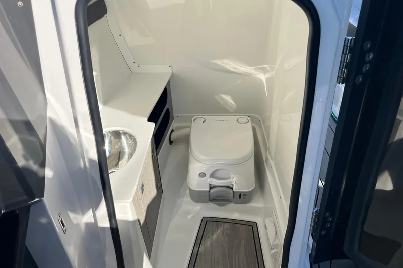 Slide: The Image of 2023 Monterey 275SS Super Sport boat interior with compact bathroom and sink. - 35