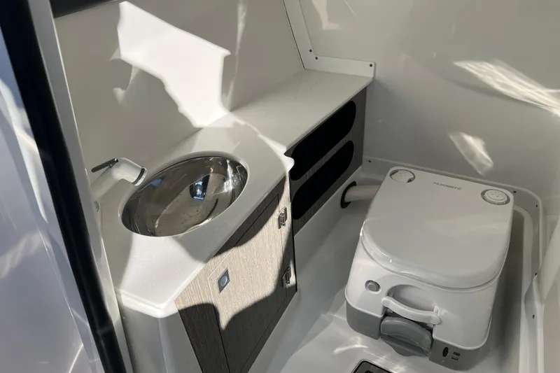 Slide: The Image of 2023 Monterey 275SS Super Sport boat bathroom with sink and portable toilet. - 38