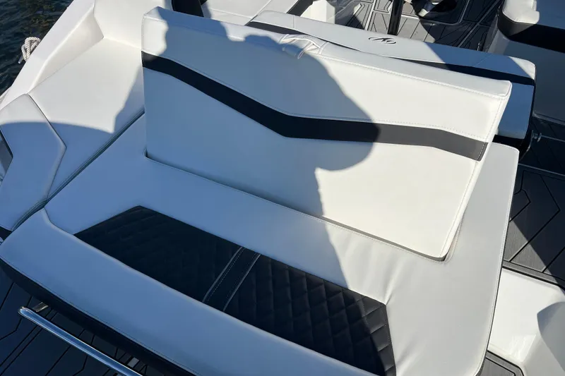 Slide: The Image of 2023 Monterey 275SS Super Sport boat seating with white and black upholstery. - 6
