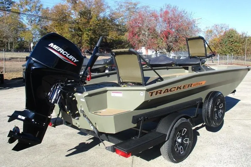Slide: The Image of 2026 Tracker Grizzly 1756 T Marsh boat with Mercury outboard motor, parked outdoors. - 3