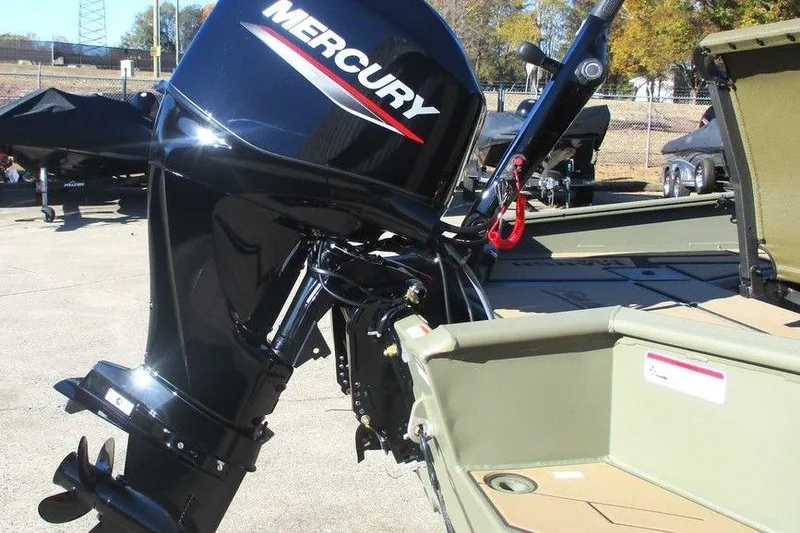 Slide: The Image of 2026 Tracker Grizzly 1756 T Marsh boat with camo design and "Fish the Flood" text. - 4