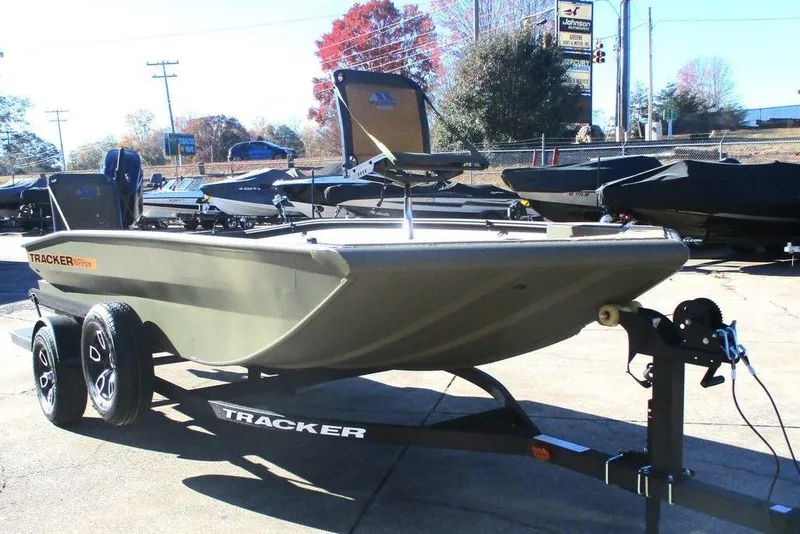 Slide: The Image of 2026 Tracker Grizzly 1756 T Marsh boat interior with camo design and storage compartment. - 7