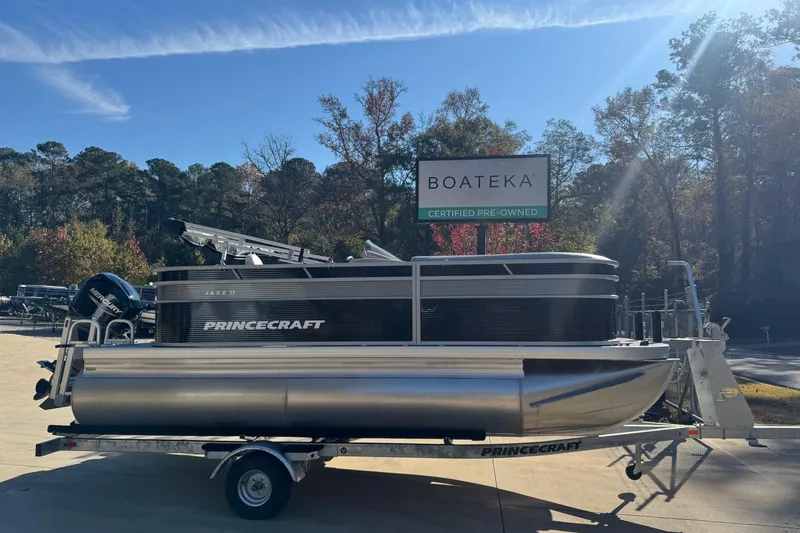The Image of 2026 Princecraft Jazz 17 pontoon boat on trailer at Boateka dealership. - 0