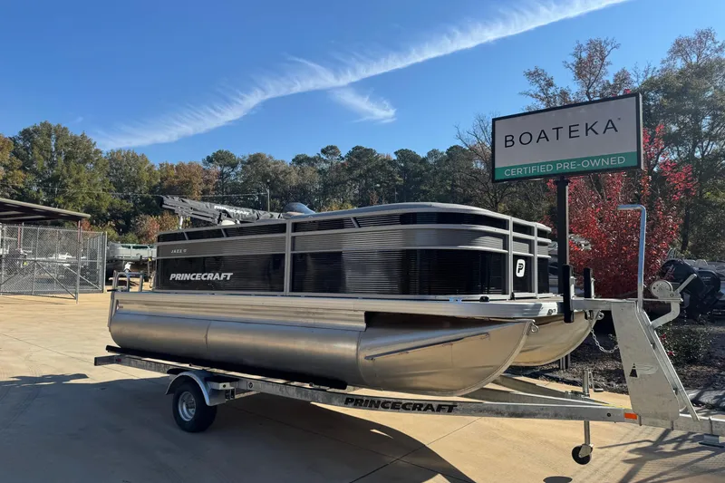 Slide: The Image of 2026 Princecraft Jazz 17 pontoon boat on trailer at Boateka, certified pre-owned. - 1