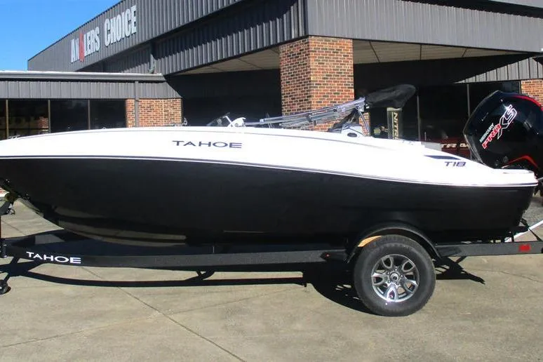 The Image of 2026 Tahoe T18 boat on trailer outside a brick building. - 1