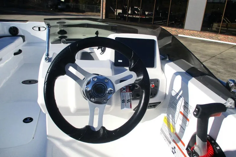 Slide: The Image of 2026 Tahoe T18 boat dashboard with steering wheel and control panel. - 3