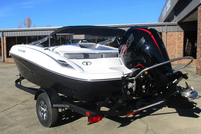 Slide: The Image of 2026 Tahoe T18 boat on trailer with powerful outboard motor, parked outdoors. - 7