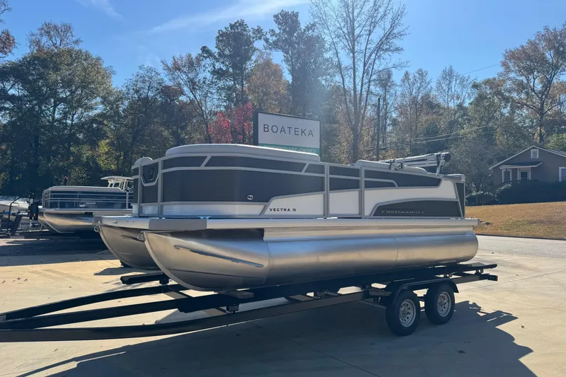 Slide: The Image of 2026 Princecraft Vectra 19 L pontoon boat on trailer in sunny outdoor setting. - 2