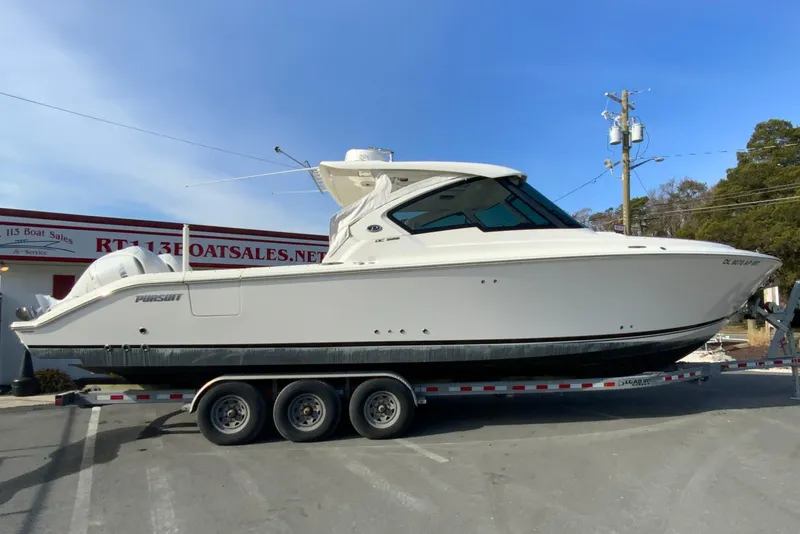The Image of 2024 Pursuit DC 326 Dual Console boat on trailer at dealership. - 0