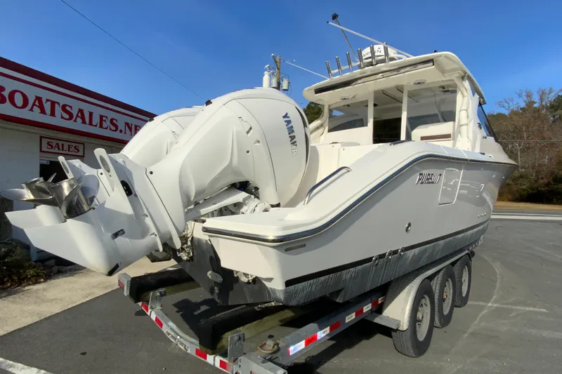 Slide: The Image of 2024 Pursuit DC 326 Dual Console boat with spacious deck and seating area. - 11