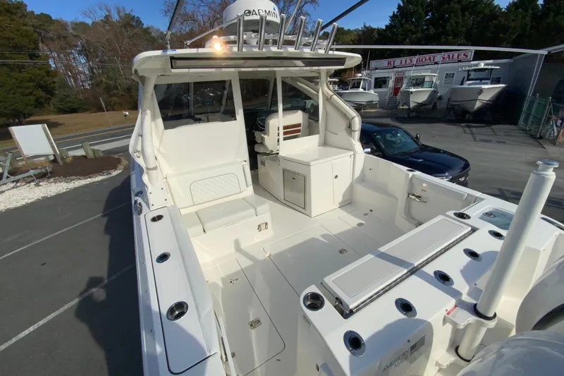 Slide: The Image of 2024 Pursuit DC 326 Dual Console boat interior, featuring spacious seating and storage areas. - 12