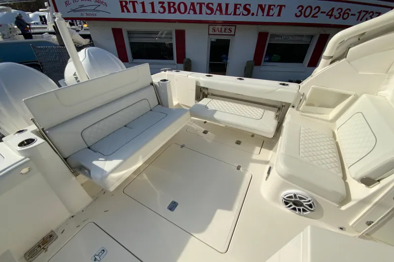 Slide: The Image of 2024 Pursuit DC 326 Dual Console boat with open storage compartment. - 16