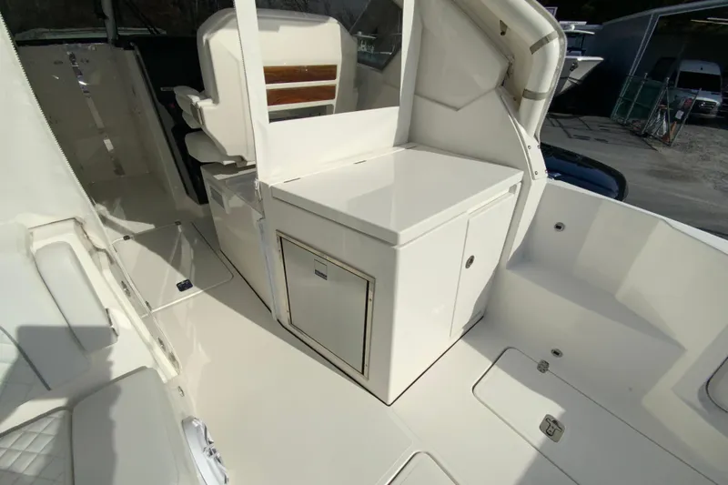 Slide: The Image of 2024 Pursuit DC 326 Dual Console boat interior with sink and grill setup. - 18