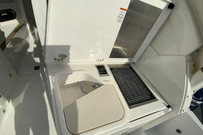 Slide: The Image of 2024 Pursuit DC 326 Dual Console boat interior with open storage compartment. - 19