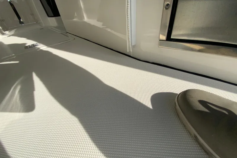 Slide: The Image of 2024 Pursuit DC 326 Dual Console interior with helm, seating, and table. - 22