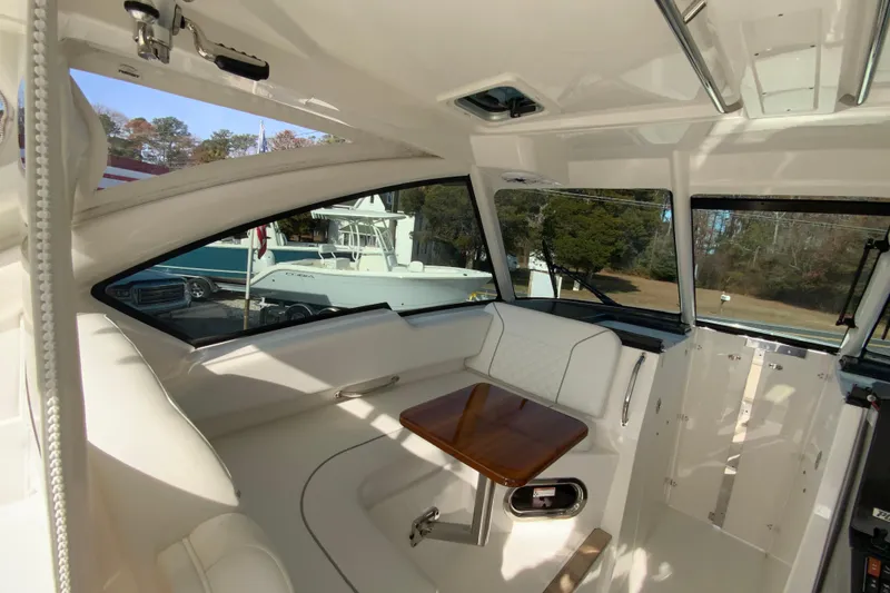 Slide: The Image of 2024 Pursuit DC 326 Dual Console boat interior with steering wheel and seating. - 24