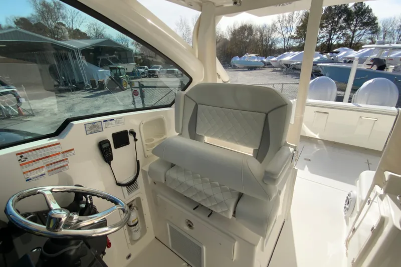 Slide: The Image of 2024 Pursuit DC 326 Dual Console interior with elegant seating and wooden table. - 25