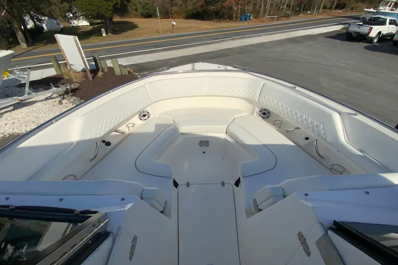 Slide: The Image of 2024 Pursuit DC 326 Dual Console interior storage compartment with white cushioned seating. - 31