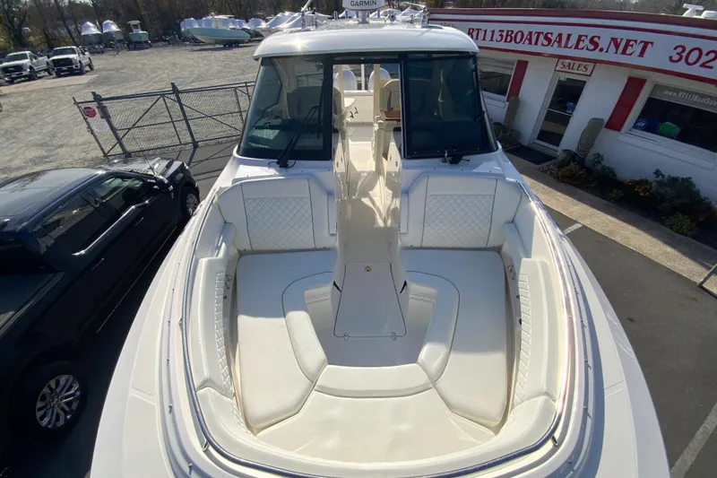 Slide: The Image of 2024 Pursuit DC 326 Dual Console boat interior with open storage compartment. - 35