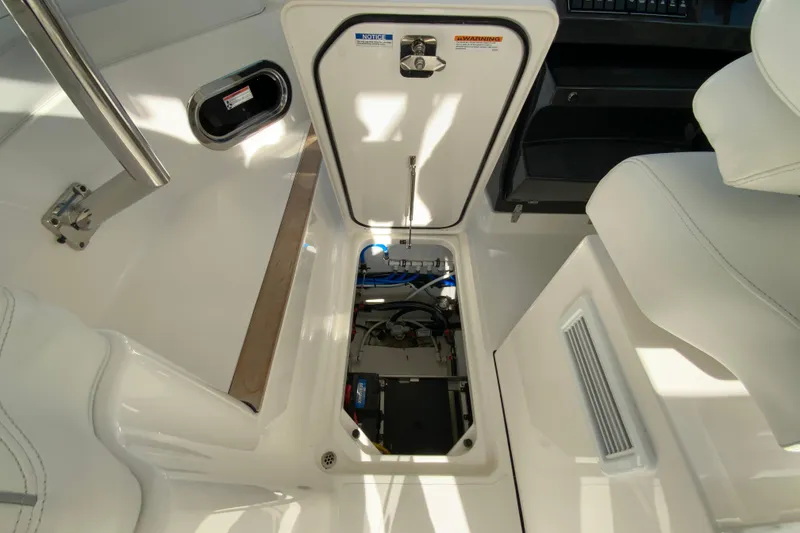 Slide: The Image of 2024 Pursuit DC 326 Dual Console boat interior showing wiring and battery compartment. - 38