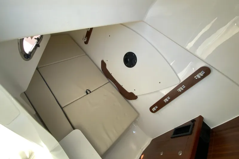 Slide: The Image of 2024 Pursuit DC 326 Dual Console electrical panel with wood finish and control switches. - 41