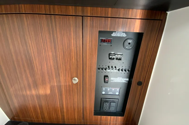 Slide: The Image of 2024 Pursuit DC 326 Dual Console cabin interior with cushioned seating and porthole. - 42