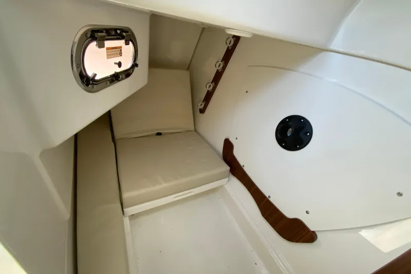 Slide: The Image of 2024 Pursuit DC 326 Dual Console cabin interior with wood paneling and seating. - 43