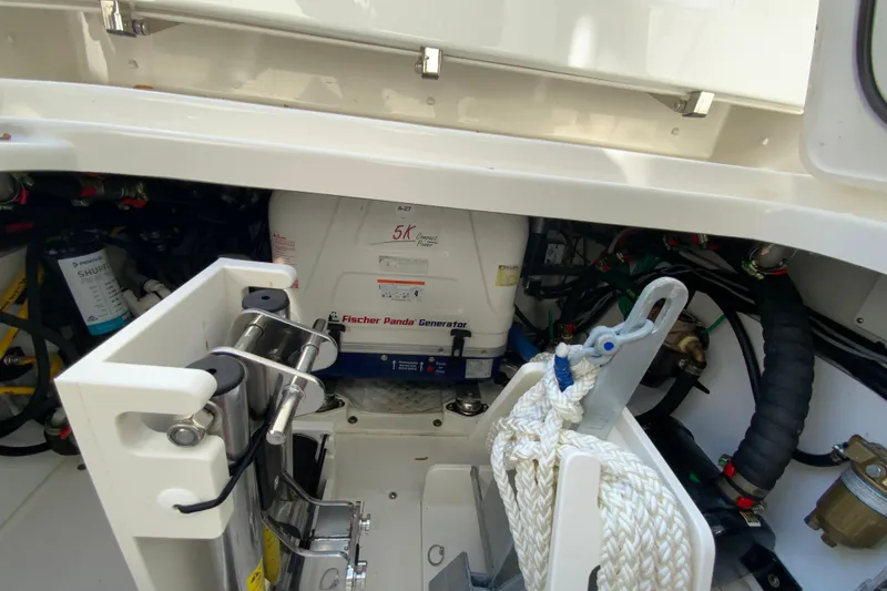 Slide: The Image of 2024 Pursuit DC 326 Dual Console boat with extended sunshade, dealership in background. - 49