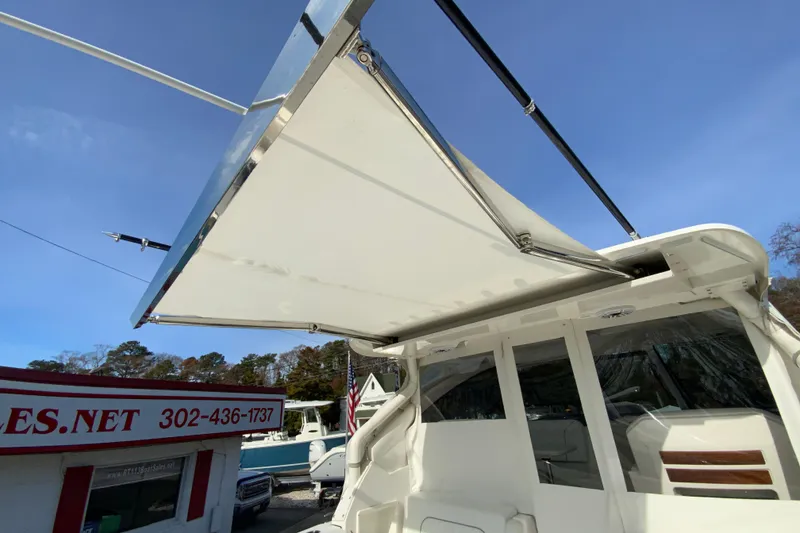 Slide: The Image of 2024 Pursuit DC 326 Dual Console boat with protective cover at dealership. - 50