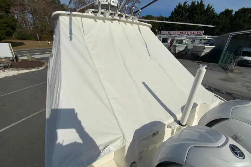 Slide: The Image of 2024 Pursuit DC 326 Dual Console boat on a trailer at a dealership. - 51